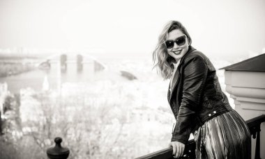 Young stylish woman walking on the city street at spring . Casual fashion modern look. Plus size model. Happy overweight woman walking the city streets