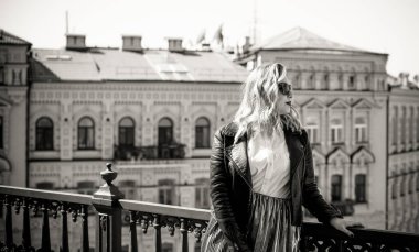 Young stylish woman walking on the city street at spring . Casual fashion modern look. Plus size model. Happy overweight woman walking the city streets