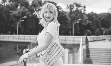 Şık giyinen genç sarışın kadın şehir sokaklarında yürüyor, şık bir bayan, moda. Artı sokaktaki boy modeli.