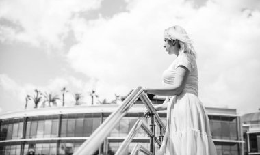 Şık giyinen genç sarışın kadın şehir sokaklarında yürüyor, şık bir bayan, moda. Artı sokaktaki boy modeli.