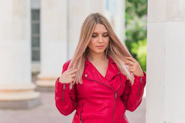 Happy woman of plus size, American or European appearance walks in the city enjoying life. Young lady with excess weight, stylishly dressed at the city park .Natural beauty