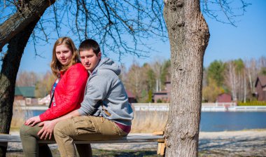 Artı parkta yürüyen çift bedenli aşıklar. Genç bir adam ve şişman bir çift tatilde.