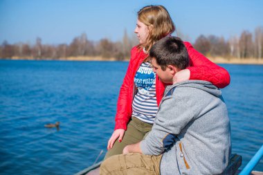 Artı parkta yürüyen çift bedenli aşıklar. Genç bir adam ve şişman bir çift tatilde.