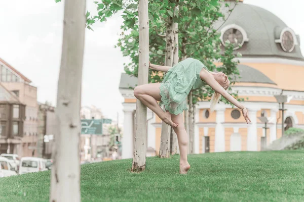 Ballerina in city. Ballet dancer dancing outdoor. Concept of freedom and sport body