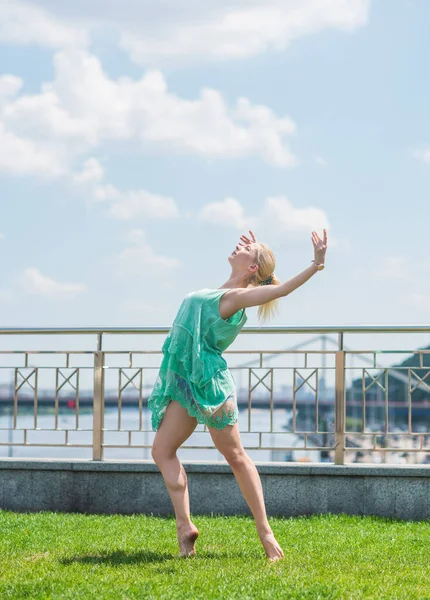 Ballerina in city. Ballet dancer dancing outdoor. Concept of freedom and sport body