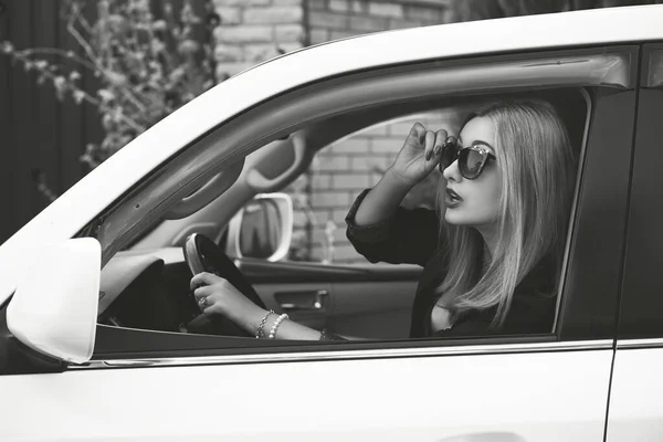 Business woman in a car, auto lady concept. Stylish lady sit in automobile
