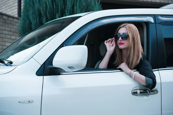 Business woman in a car, auto lady concept. Stylish lady sit in automobile