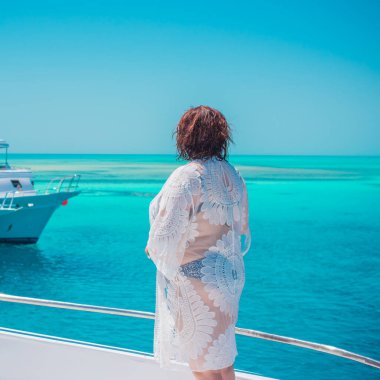  Ayrıca Mısır 'da yatta orta yaşlı bir kadın. Tatil ve rahatlama konsepti. Afrika' ya seyahat.