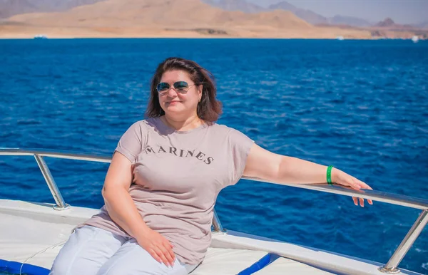 Plus size middle age woman at Egypt at yacht, vacation and relax concept, travel to Africa