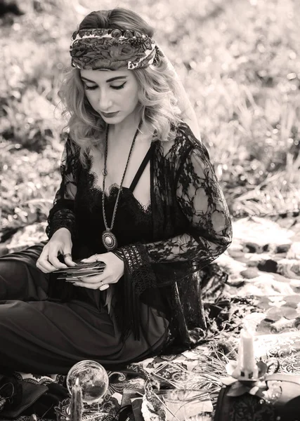 Gypsy soul... Boho woman with Tarot cards, candles and magic ball at field, lifestyle, predicting, ideas for costume on Halloween