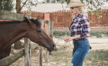 Amerikan tarzı, atıyla konuşan bir kadın. Ekose gömlekli bir kadınla ata binmenin portresi, Rancho 'daki bir kadınla at binmenin portresi