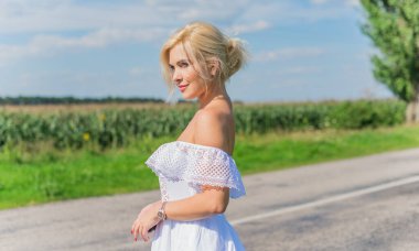 Özgürlük konsepti, yeşil tarladaki kadının romantik fotoğrafı, akşam güneşi, beyaz elbiseli güzel romantik kız. Güneş ışığı