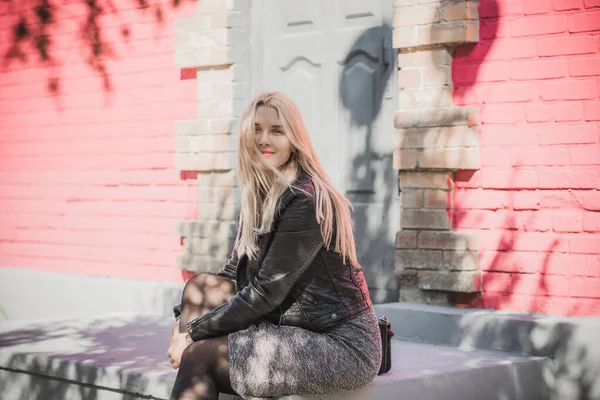 Happy woman of plus size, American or European appearance enjoying life. Young lady with excess weight, stylishly dressed at city street. Natural beauty