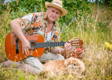 Funny older man in print shirt tourist playing guitar and sing song on nature outdoors, trip to America and pleasure for vacation clipart