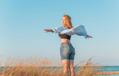 Deniz kenarında dinlenen dolgun kalçalı Avrupalı kadın mayo giydiğini gösterdi. 