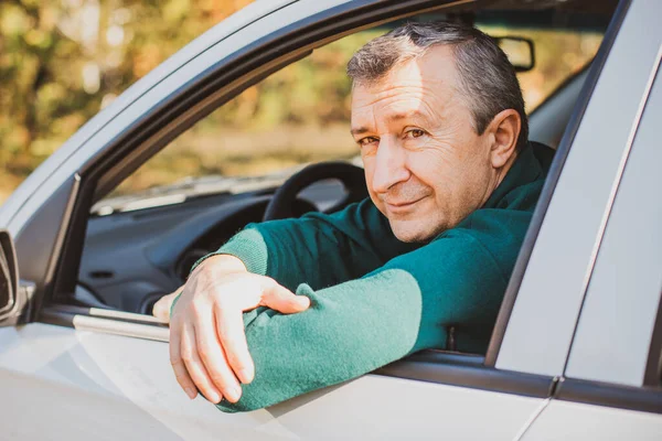 Stock image Portrait Of A Mature man Driving Car To Go To Work or travels. Concept of automobile and popular hobby