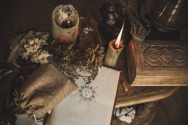 Magical attribute on a table, witchcraft concept, Candle fire, Spells and other rituals