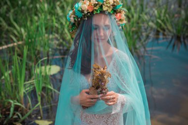 Bride making magic of candles, magical attributes, herbs and flowers, Slavic/ Wicca rituals and esoteric concept