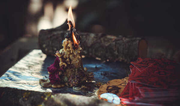 Candle burns on the altar, magic among candles, clean negative energy, wicca concept