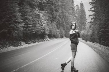 Yoldaki güzel kadın. Seyahat konsepti, macera ve yolculuk zamanı. Şık bir kadın, macera ve seyahat kavramı ya da hafta sonu dinlenme, atmosferik bir an.