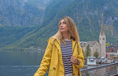 Sarı Ceketli Kadın Hallstatt Gölü, Avusturya 'ya hayran. Alp Köyünde Seyahat ve Turizm Konsepti