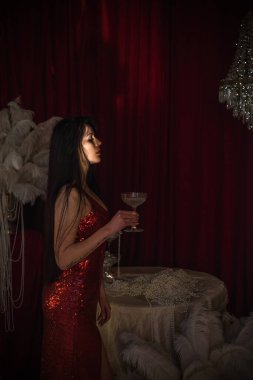  Parlak kırmızı elbiseli, esmer, tutkulu bir kadın. 