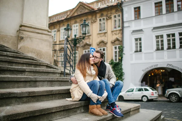 Young hipster couple  with coffee kissing, hugging in old town — Stock Photo, Image