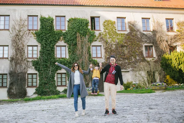 Happy young family, father and mother keep son's hands outdoors — Stock Photo, Image