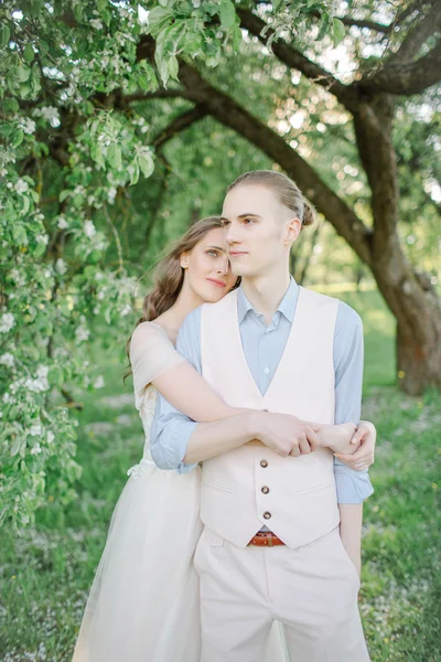 Young pretty bride in wedding dress with handsome groom outdoors — Stock Photo, Image