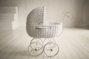 Beautiful old fashioned white pram in white room