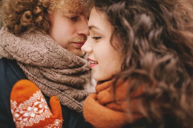 Genç kıvırcık çift birbirine sevgiyle bakarak