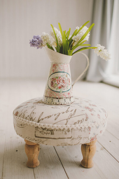Spring flowers in a vase on retro banquette