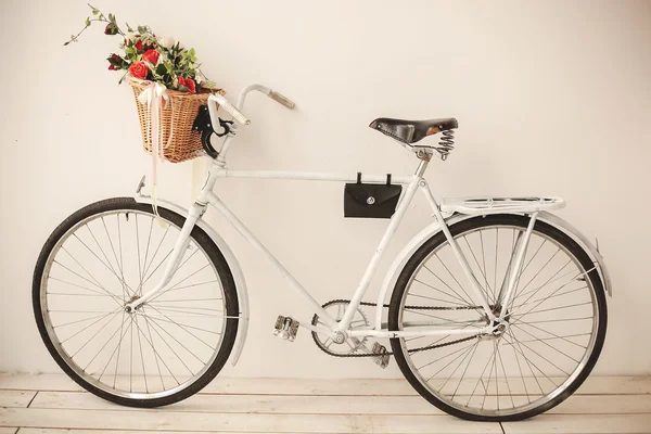 White retro bicycle on white wooden floor — Stock Photo, Image