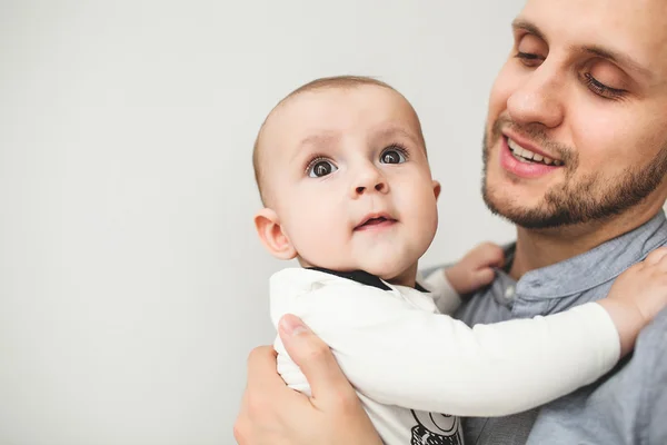 Happy father holding baby son in hands with isolated background — Stock Photo, Image