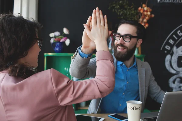 Modern team celebrating success giving five with laptop — Stock Photo, Image