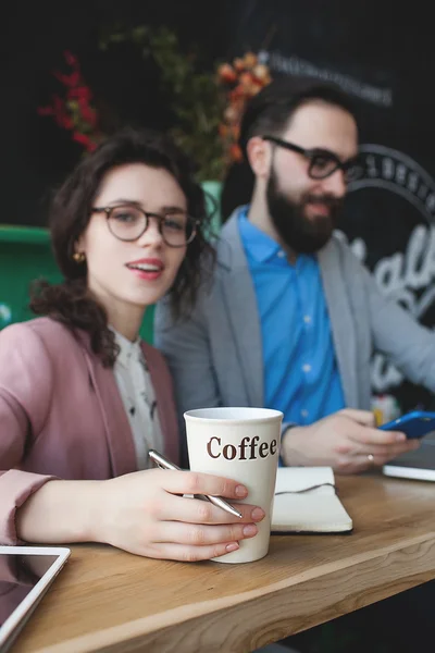 Equipo moderno que trabaja en la cafetería con el ordenador portátil, teléfono inteligente con café —  Fotos de Stock