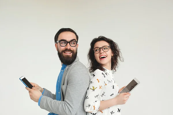 Hipster team in glasses with smartphone tablet isolated on white — Stock Photo, Image