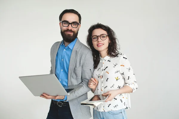 Hipster team in glasses with laptop tablet isolated on white — Stock Photo, Image