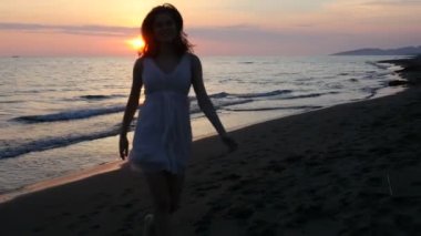 gün batımını kumsalda güzel genç kadının