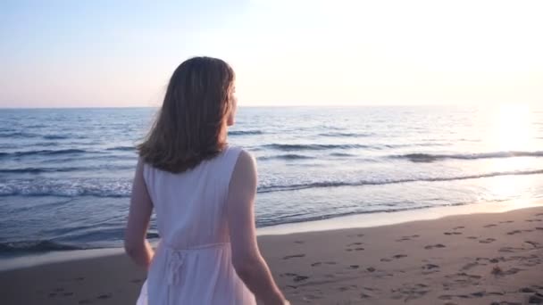Schöne junge Frau läuft am Strand — Stockvideo