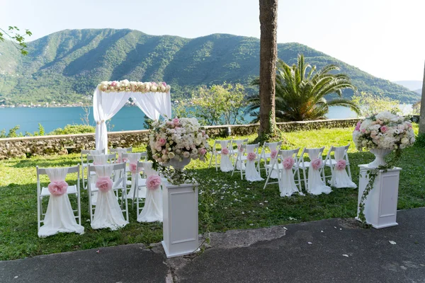 Arco per la cerimonia nuziale, decorato con stoffa e fiori — Foto Stock