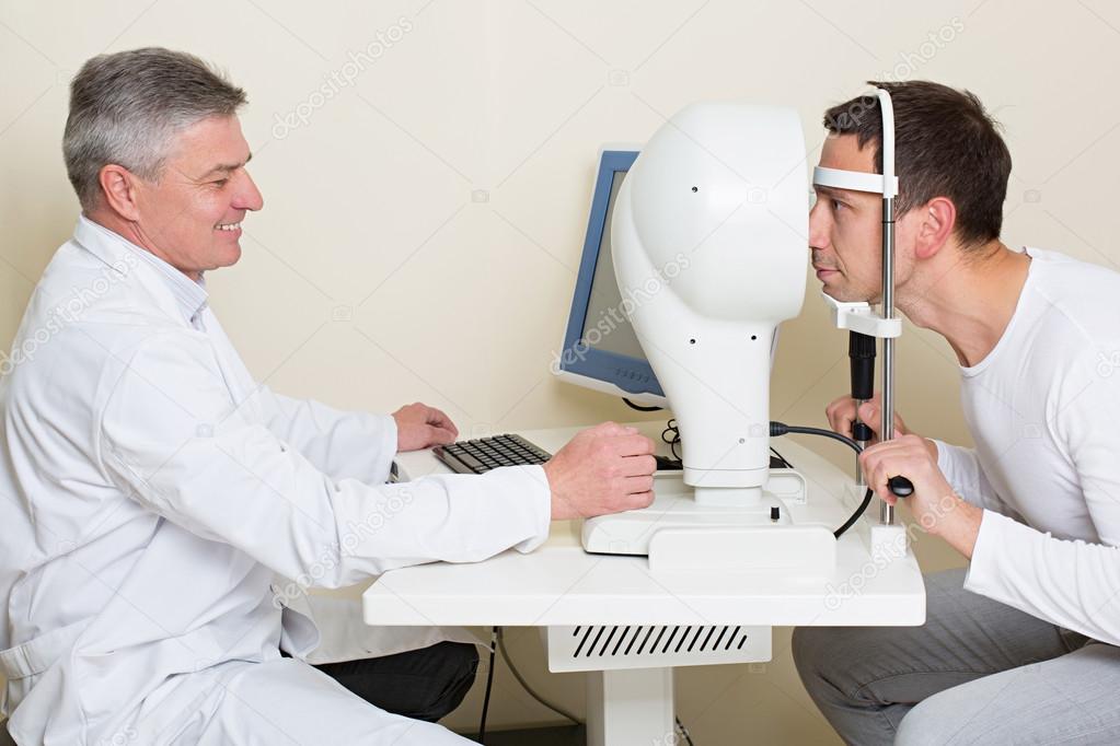 Man having his eyes examined by an eye elderly doctor.