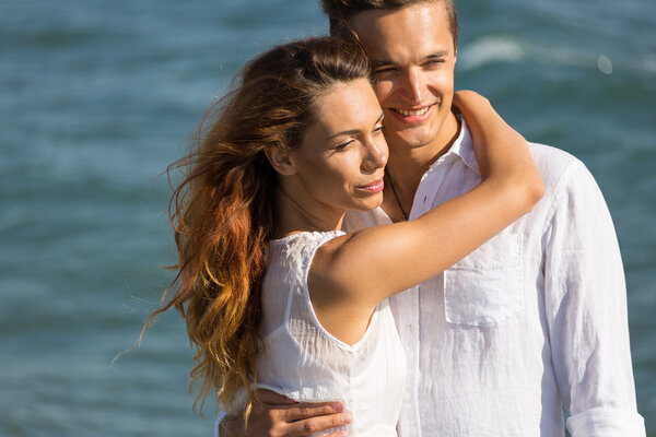 happy couple in love walking on the beach