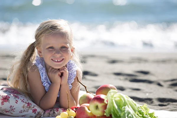 Маленькая девочка наслаждается пикником на пляже Лицензионные Стоковые Изображения