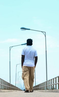 İskele ya da iskele, yaya yolu gezinti güvertesi ve gün doğumunda deniz. Arka plan için iskelenin güzel manzarası. Jetty 'nin yanından geçen çocuk..