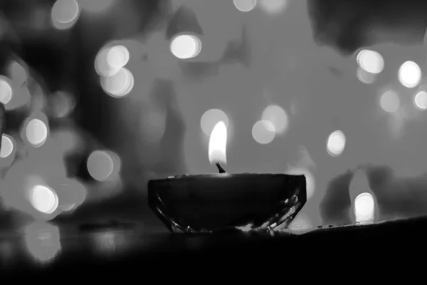 Candle lights in darkness with colorful light effects and bokeh for solemn moments and wallpaper. Candle flame light at night with the background.
