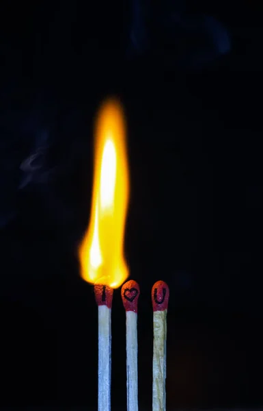 I Love You on Match Sticks. Matchstick art photography used matchsticks to create a love concept. Close-up of burnt matchsticks.