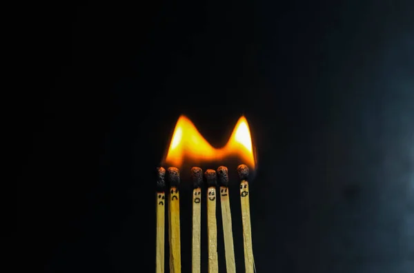 Group of a red match burning isolated with the background. Row burning matchstick in the chain reaction. Matchstick art photography.