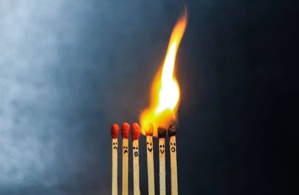 Group of a red match burning isolated with the background. Row burning matchstick in the chain reaction. Matchstick art photography.