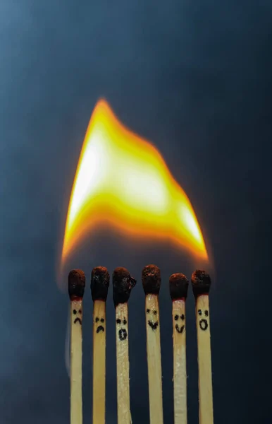 Group of a red match burning isolated with the background. Row burning matchstick in the chain reaction. Matchstick art photography.